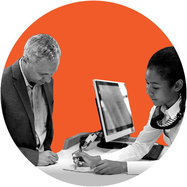 man and woman at a desk signing up for membership